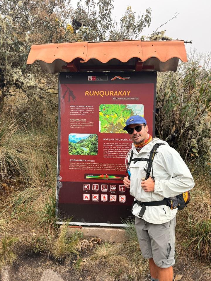 Tom at the Runqurakay Pass trail sign in Peru